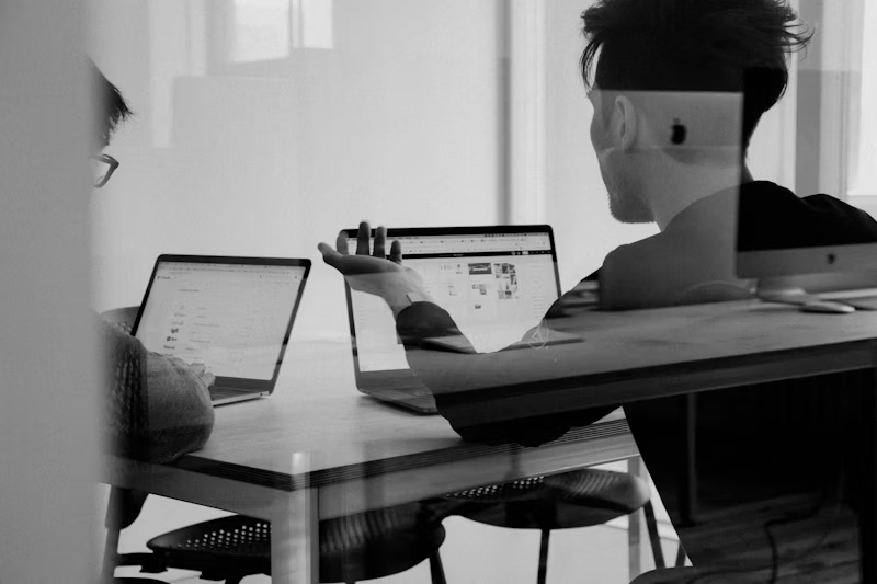 Finance professionals discussing strategy around a table